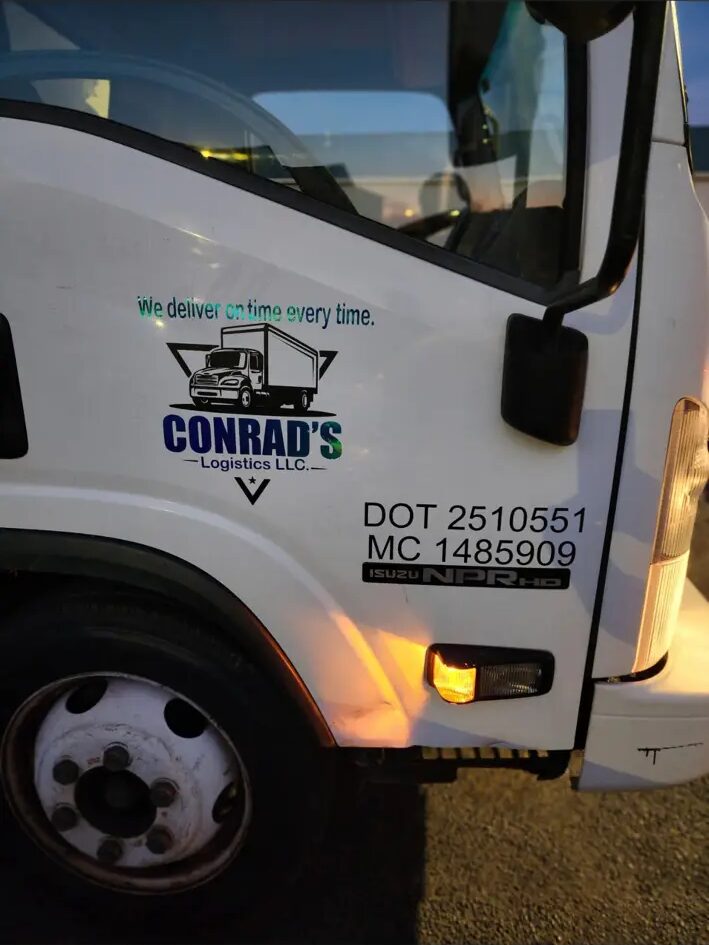 Conrad Logistics box truck door showing the company logo, DOT 2510551 and MC 1485909